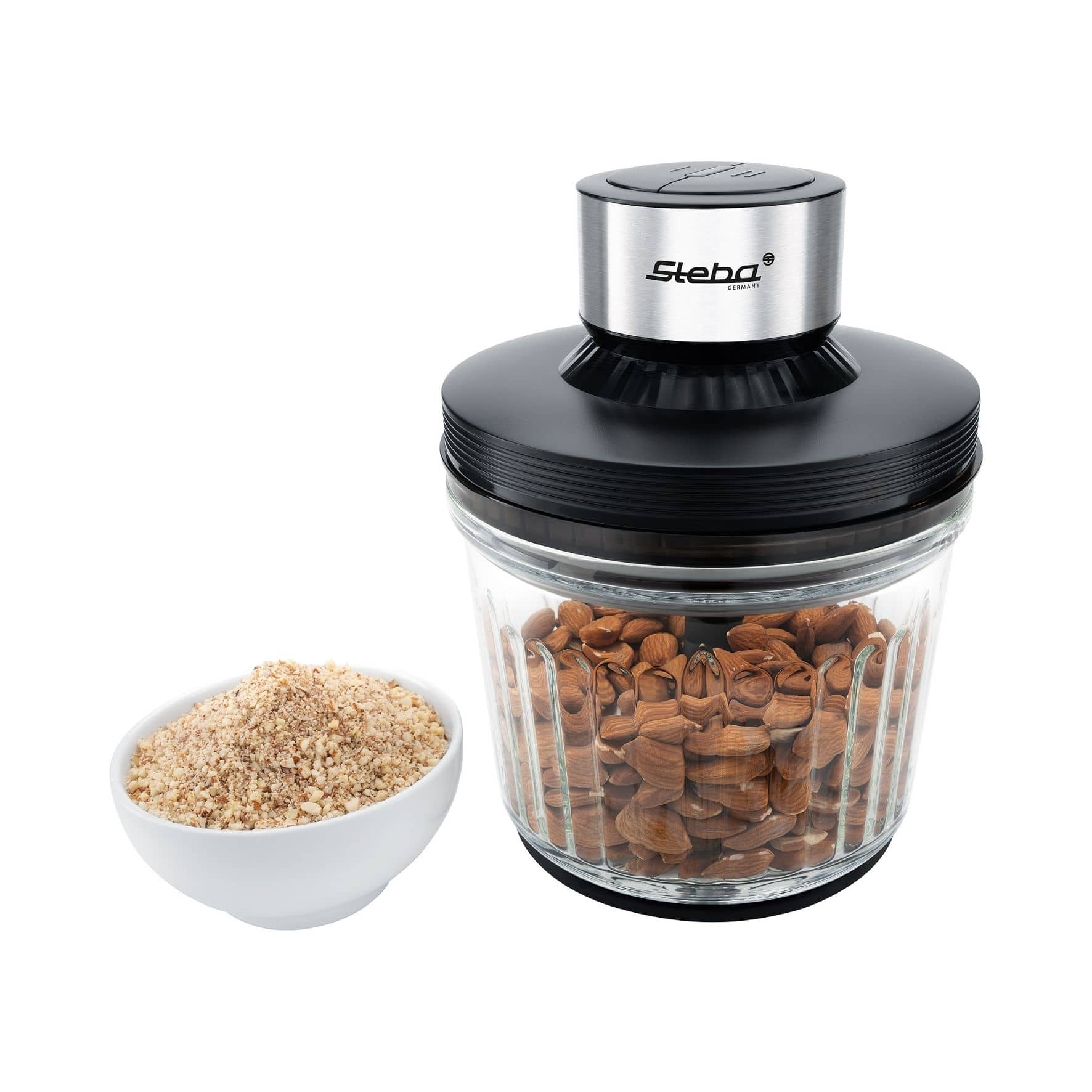 Steba MG 400 Multi-Zerkleinerer mit transparentem Behälter und Edelstahl-Deckel; daneben eine Schüssel mit gemahlenen Nüssen.